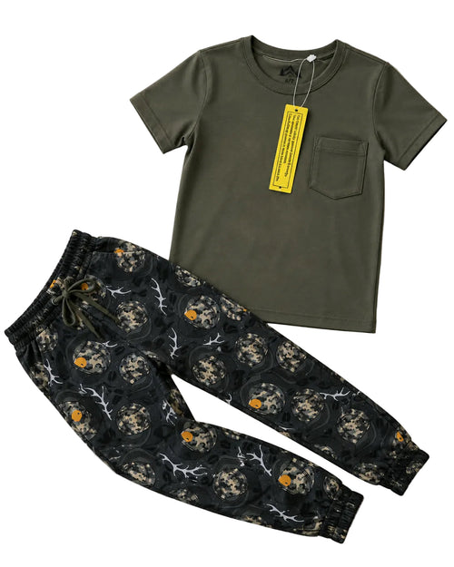 Green t-shirt and patterned pants on a light background