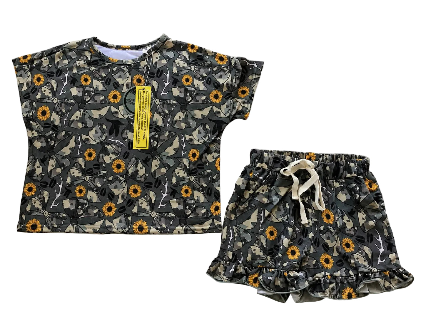 Children's floral outfit with top and shorts on a light gray background