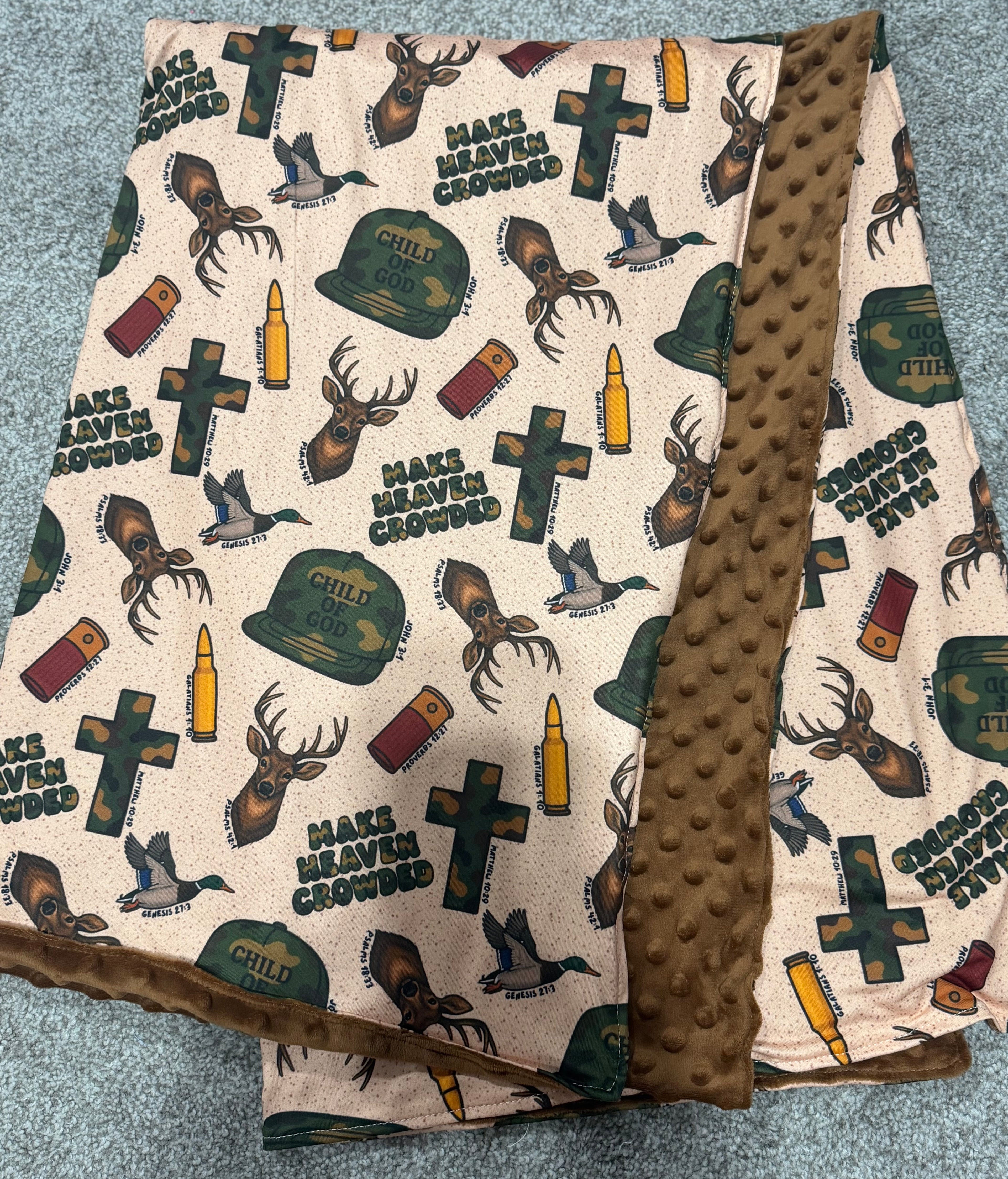 Baby blanket with hunting-themed design on a textured surface