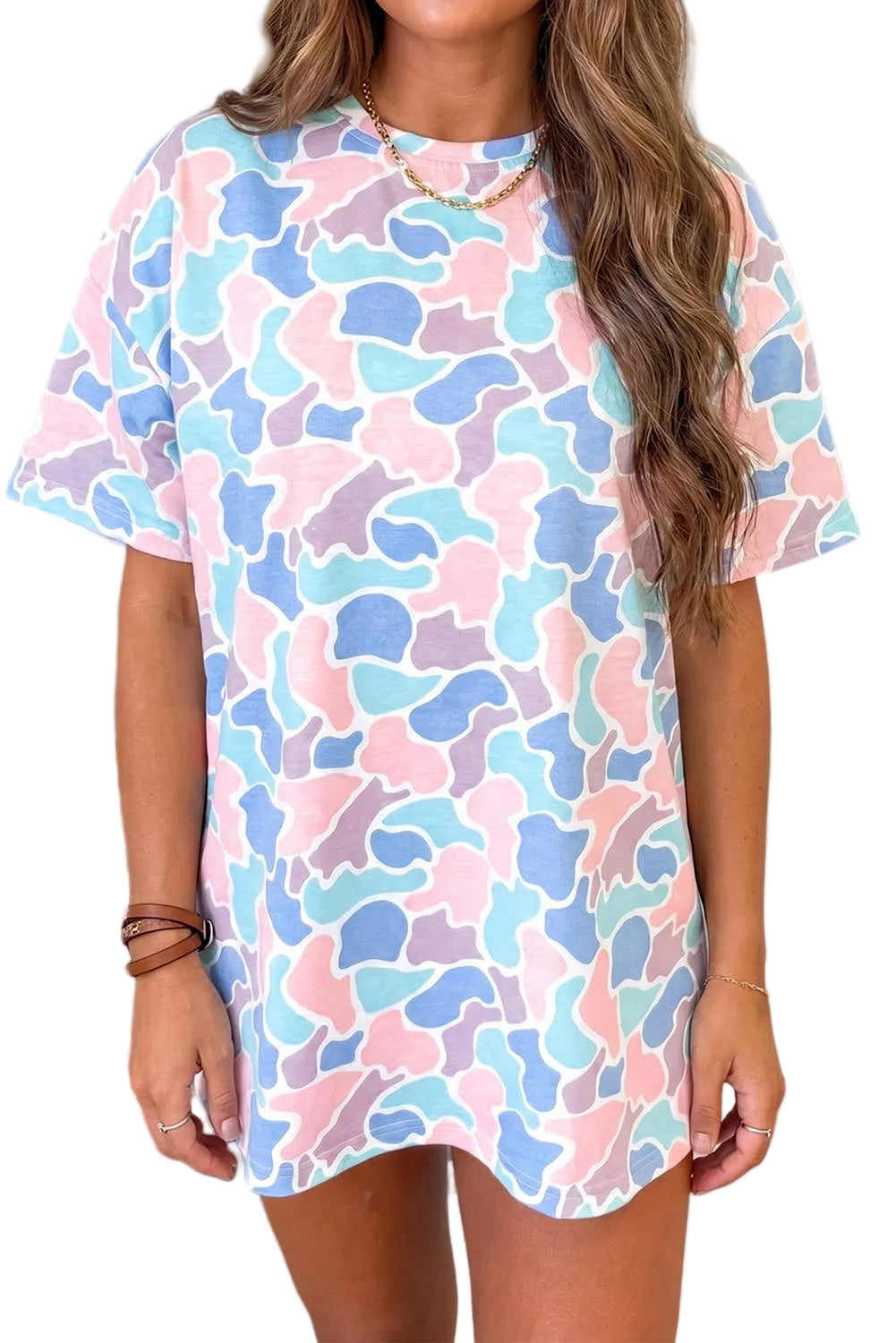 Woman wearing a pastel camouflage dress outdoors.